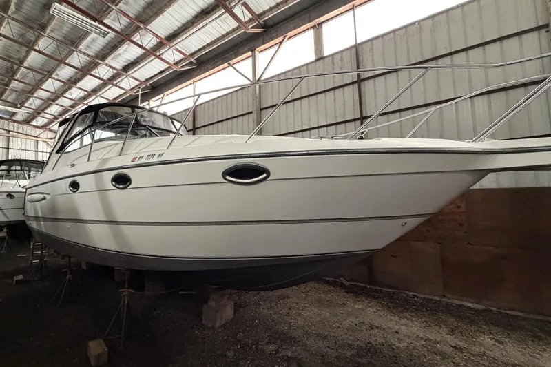 Slide: The Image of 2001 Maxum 3300 SCR boat stored indoors, showcasing sleek design and sturdy build. - 43