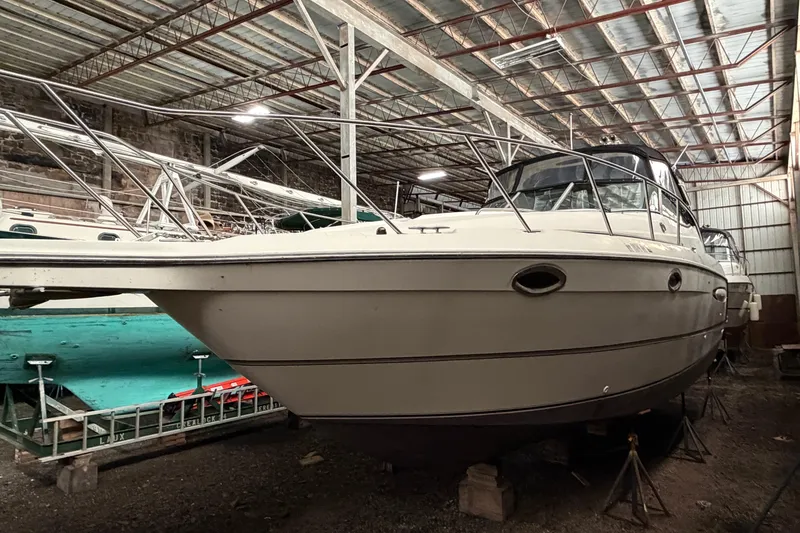 Slide: The Image of 2001 Maxum 3300 SCR boat stored indoors, showcasing sleek design and sturdy construction. - 44