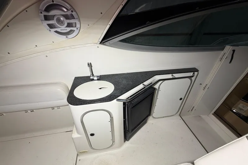 Slide: The Image of 2001 Maxum 3300 SCR boat interior with sink, countertop, and storage cabinets. - 50