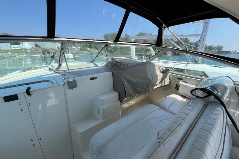 Slide: The Image of 2001 Maxum 3300 SCR boat interior with white seating and clear canopy. - 6