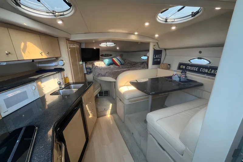 Slide: The Image of Luxurious interior of 2001 Maxum 3300 SCR yacht with kitchenette and cozy seating area. - 7