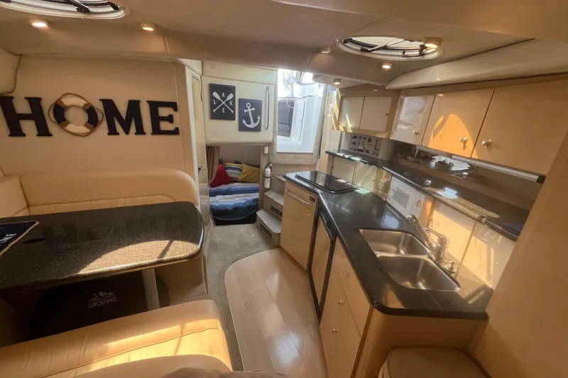 Slide: The Image of Luxurious interior of 2001 Maxum 3300 SCR yacht with modern kitchen and cozy seating area. - 9