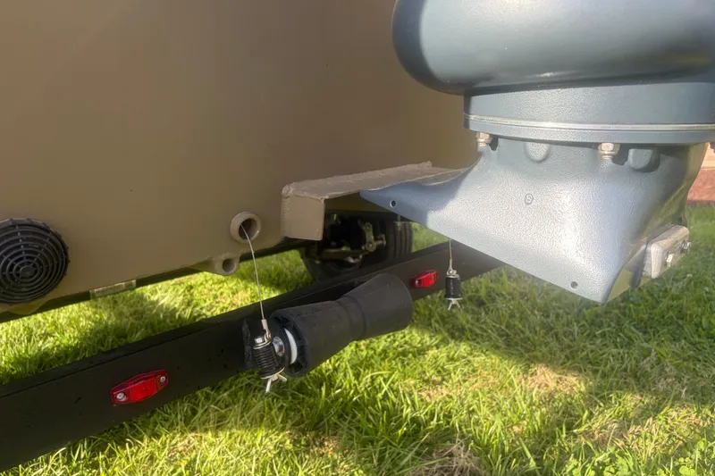 Slide: The Image of Close-up of 2026 G3 Gator Tough Tunnel Jon 18 CCJ boat's engine and trailer components. - 12