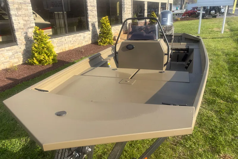 Slide: The Image of 2026 G3 Gator Tough Tunnel Jon 18 CCJ boat on grass, near building. - 5