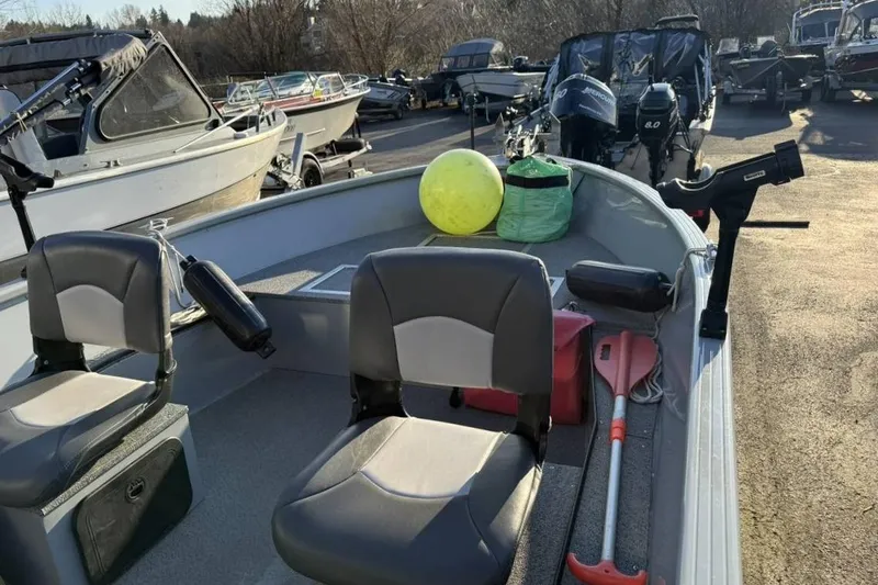Slide: The Image of 2021 Smoker Craft 16 Lodge boat with seating and fishing gear on deck. - 3
