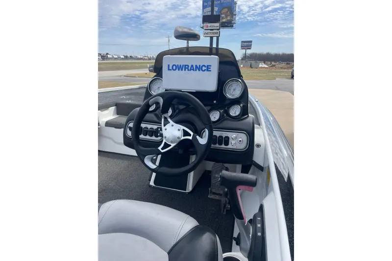 The Image of 2011 Nitro Z-8 DC boat dashboard with Lowrance display and steering wheel. - 0