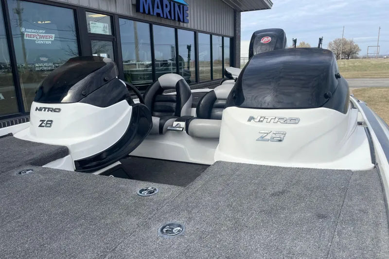 Slide: The Image of 2011 Nitro Z-8 DC boat dashboard with Lowrance display and steering wheel. - 2