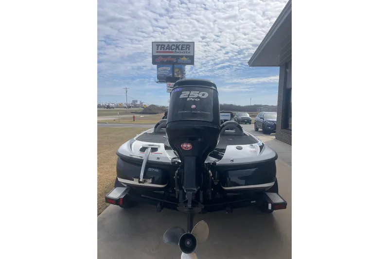 Slide: The Image of 2011 Nitro Z-8 DC boat with 250 Pro motor, parked near Tracker Boats sign. - 4