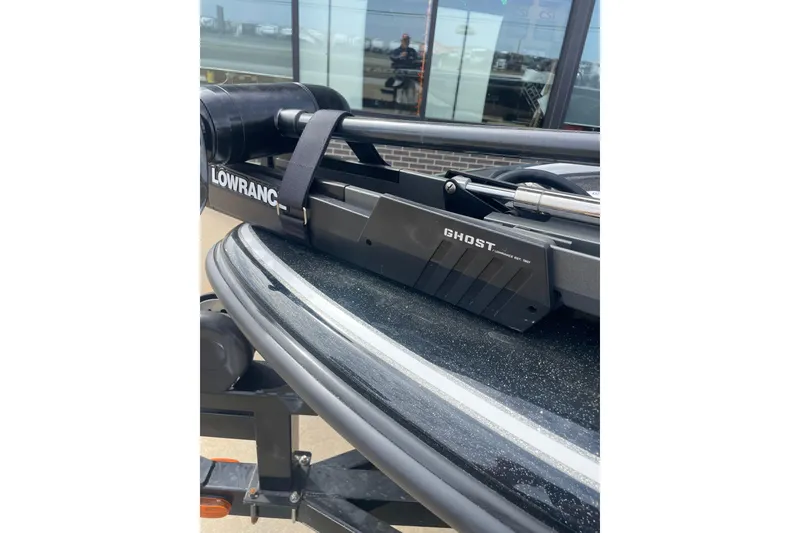 Slide: The Image of 2011 Nitro Z-8 DC boat with Lowrance equipment on deck, parked outdoors. - 8