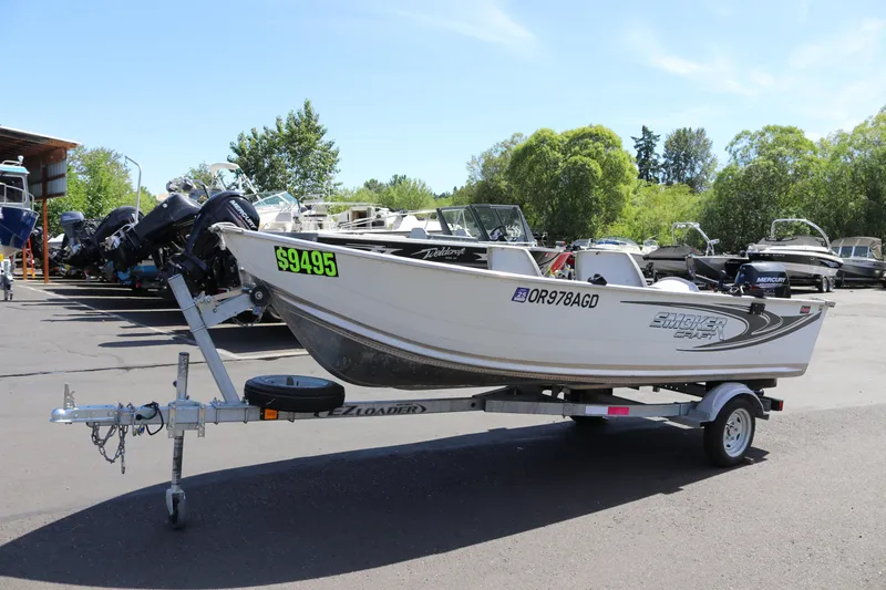Slide: The Image of 2018 Smoker Craft Alaskan 15 boat on trailer, priced at $9495, in outdoor lot. - 4