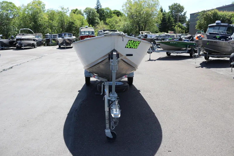 Slide: The Image of 2018 Smoker Craft Alaskan 15 boat on trailer, priced at $9495, in outdoor dealership. - 5
