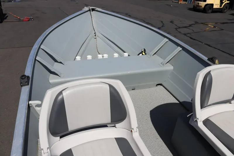 Slide: The Image of 2018 Smoker Craft Alaskan 15 boat interior with seating and storage compartments. - 6