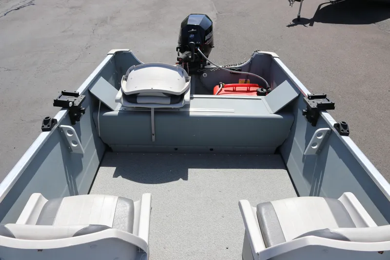 Slide: The Image of 2018 Smoker Craft Alaskan 15 boat interior with seating and motor. - 8