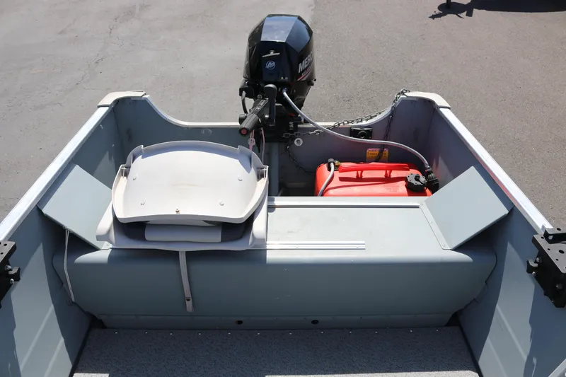 Slide: The Image of 2018 Smoker Craft Alaskan 15 boat interior with motor and fuel tank. - 9