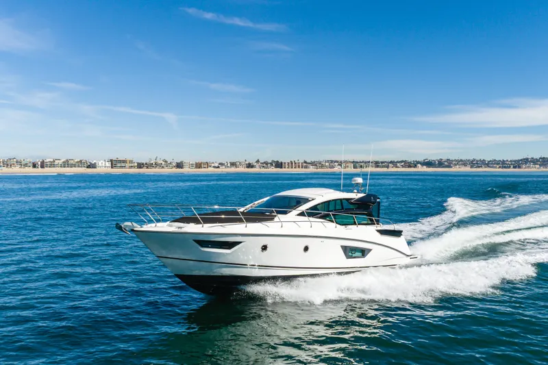 Slide: The Image of 2019 Beneteau Gran Turismo 46 yacht cruising on open water under clear blue skies. - 10