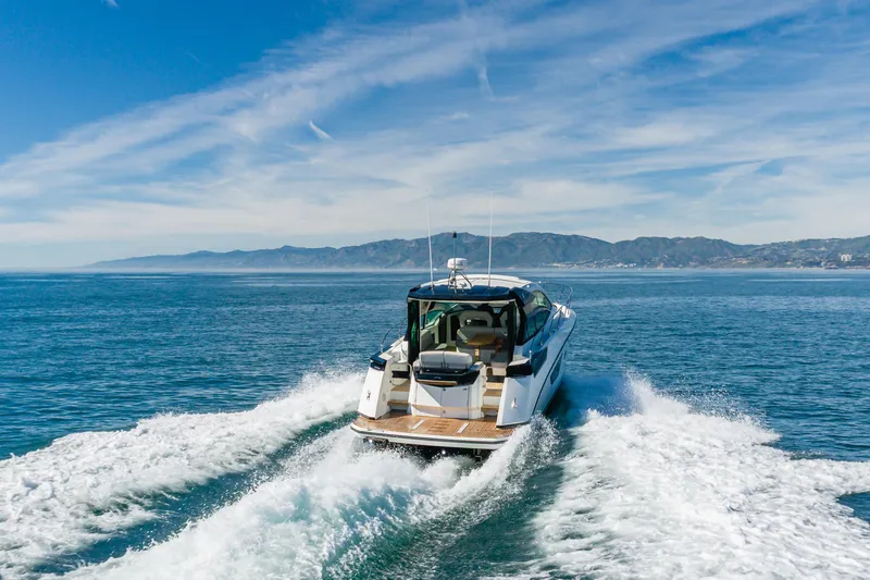 Slide: The Image of 2019 Beneteau Gran Turismo 46 cruising on open water with scenic coastline backdrop. - 12