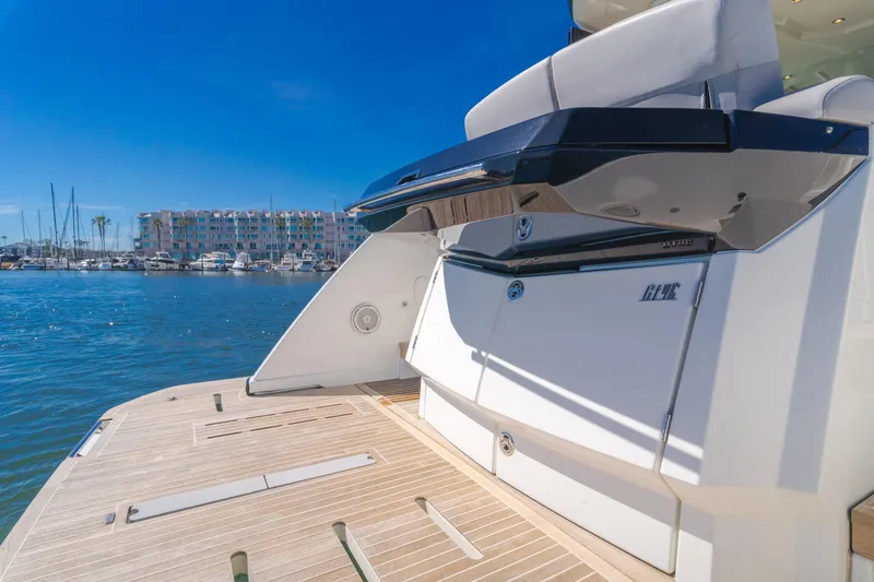 Slide: The Image of 2019 Beneteau Gran Turismo 46 yacht stern view at marina, showcasing sleek design. - 15