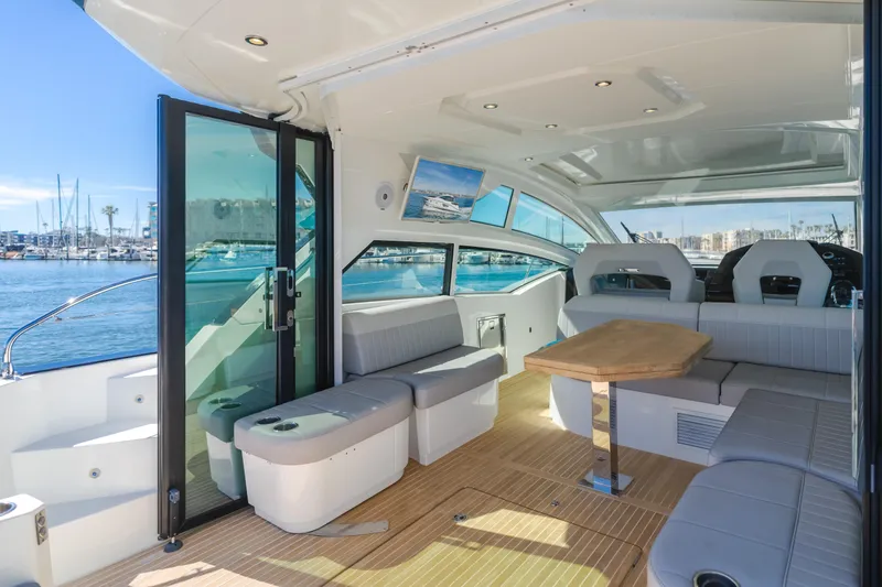 Slide: The Image of Luxurious interior of 2019 Beneteau Gran Turismo 46 yacht with elegant seating and wooden table. - 17