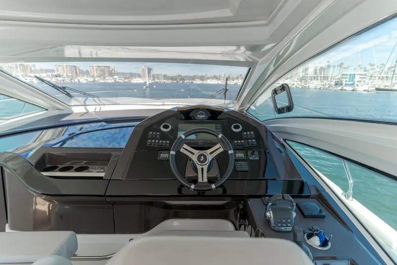 Slide: The Image of Helm of 2019 Beneteau Gran Turismo 46 yacht with panoramic marina view. - 23