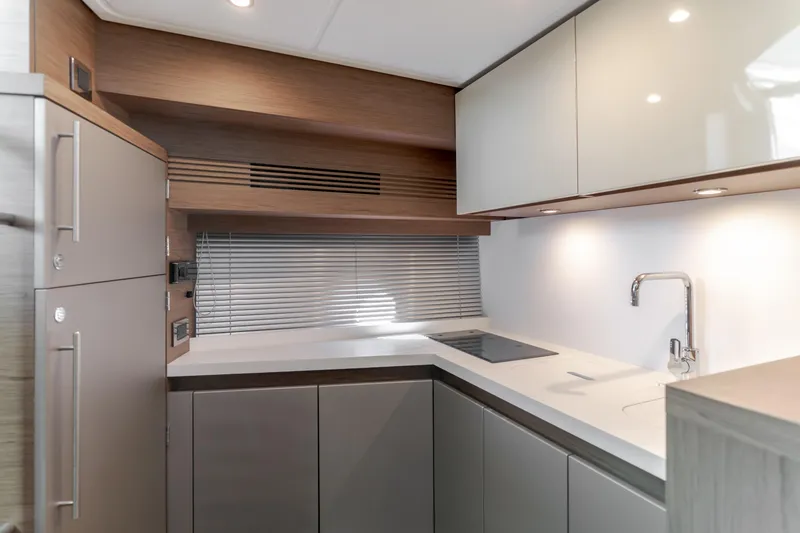 Slide: The Image of Modern kitchen interior of 2019 Beneteau Gran Turismo 46 yacht, featuring sleek cabinetry and appliances. - 29