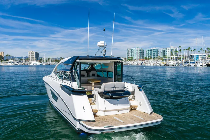 Slide: The Image of 2019 Beneteau Gran Turismo 46 yacht cruising in a marina with cityscape background. - 3