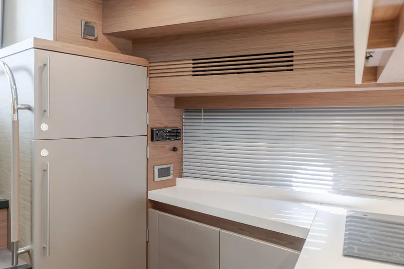 Slide: The Image of Modern kitchen interior of 2019 Beneteau Gran Turismo 46 yacht with sleek cabinetry and appliances. - 30