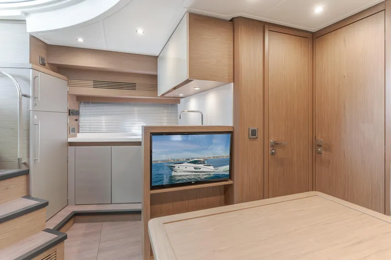 Slide: The Image of Luxurious interior of 2019 Beneteau Gran Turismo 46 yacht with modern kitchen and TV. - 32
