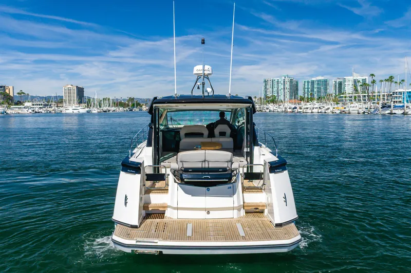Slide: The Image of 2019 Beneteau Gran Turismo 46 yacht cruising in a marina with city skyline. - 4