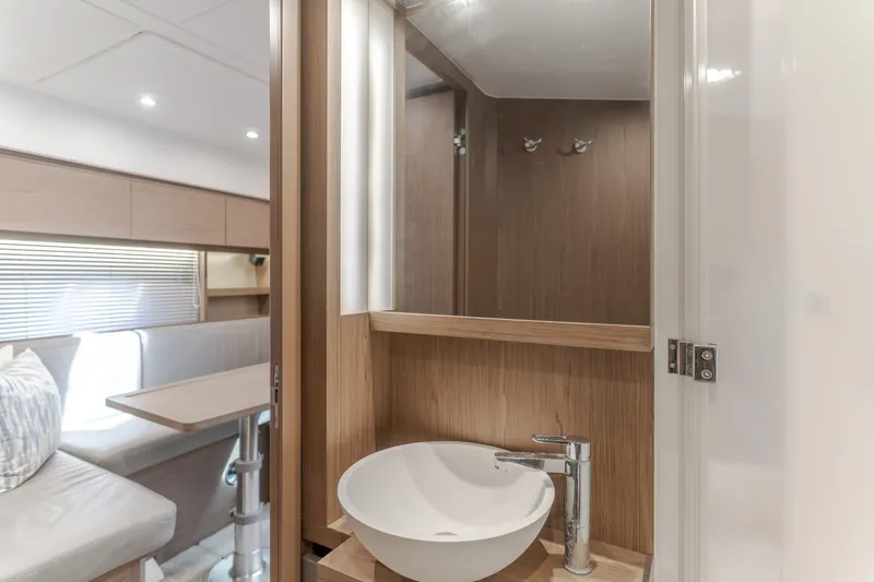 Slide: The Image of Luxurious interior of 2019 Beneteau Gran Turismo 46 yacht with modern sink and seating area. - 40