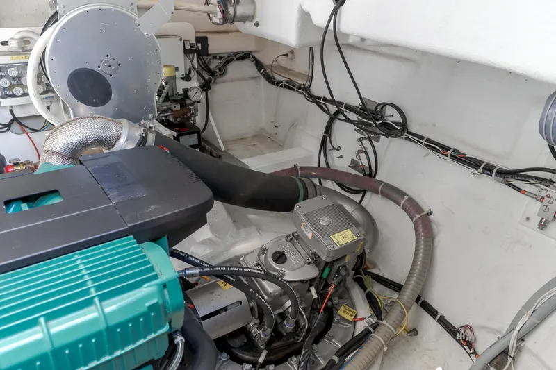 Slide: The Image of Engine room of 2019 Beneteau Gran Turismo 46 yacht, showcasing mechanical components and wiring. - 46