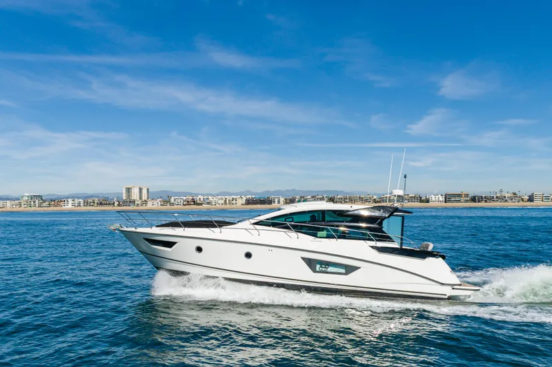 Slide: The Image of 2019 Beneteau Gran Turismo 46 yacht cruising on open water under clear blue skies. - 9