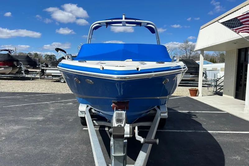 Slide: The Image of 2017 Chaparral 227 SSX Surf boat on trailer under blue sky. - 12