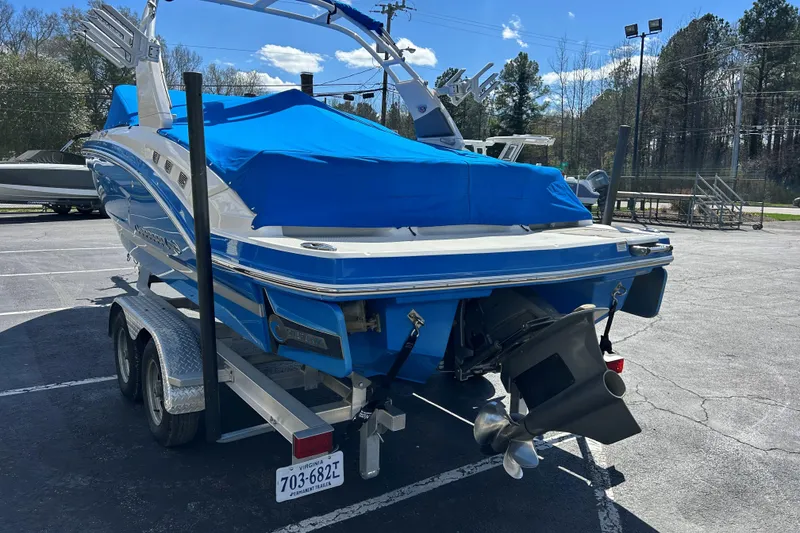 Slide: The Image of 2017 Chaparral 227 SSX Surf boat on trailer, covered in blue tarp. - 14