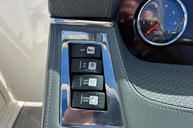 Slide: The Image of Control panel of a 2017 Chaparral 227 SSX Surf boat with switches and RPM gauge. - 19