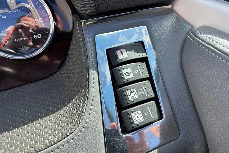 Slide: The Image of Dashboard controls of a 2017 Chaparral 227 SSX Surf boat with speedometer and switches. - 21