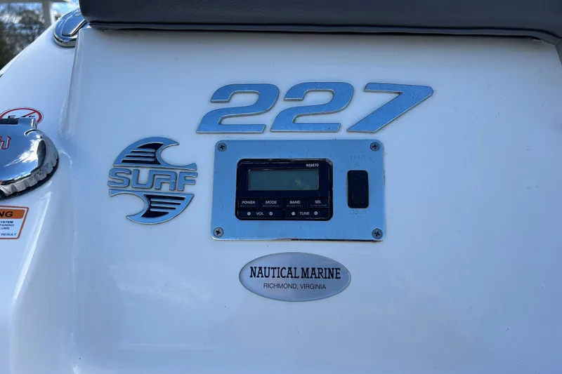 Slide: The Image of 2017 Chaparral 227 SSX Surf boat dashboard with control panel and branding. - 29