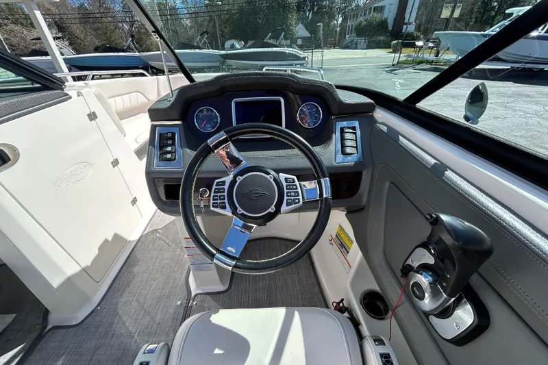 Slide: The Image of 2017 Chaparral 227 SSX Surf boat cockpit with steering wheel and control panel. - 31
