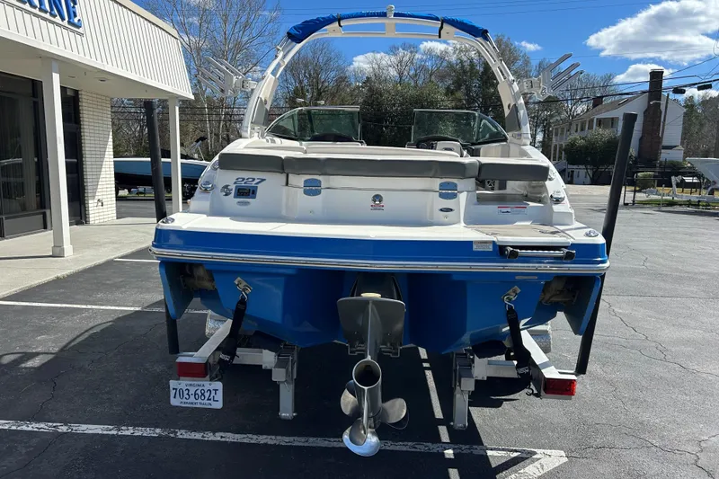Slide: The Image of 2017 Chaparral 227 SSX Surf boat, blue and white, parked outdoors. - 7