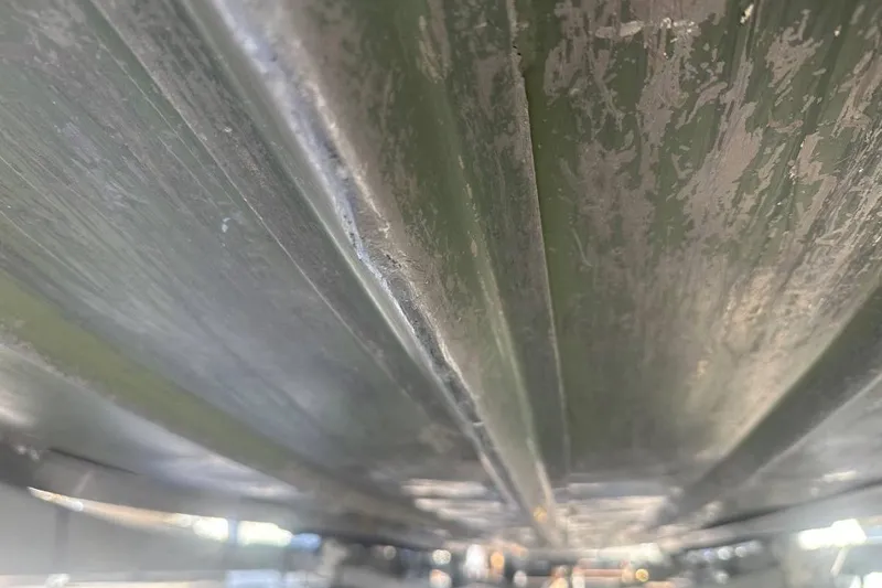 Slide: The Image of Close-up of the underside of a 2002 Smoker Craft Sportsman 1860 DLX boat hull. - 11