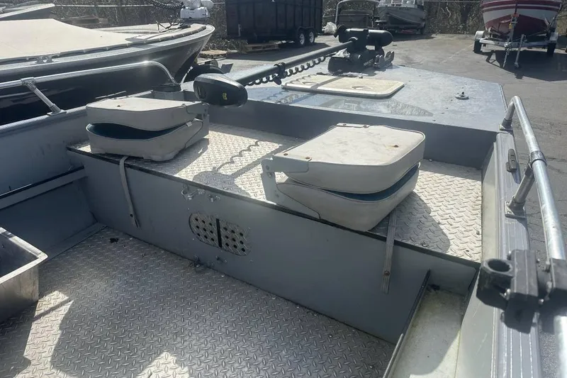 Slide: The Image of 2002 Smoker Craft Sportsman 1860 DLX boat interior with seating and metal flooring. - 3