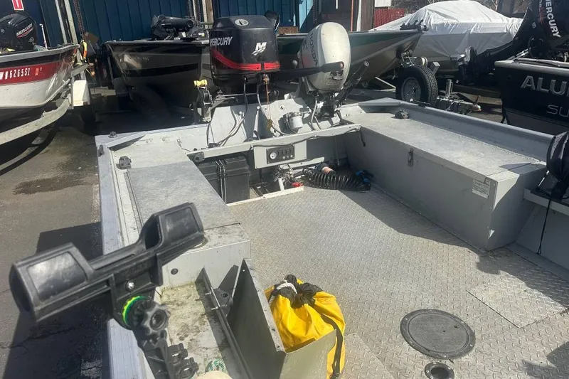 Slide: The Image of 2002 Smoker Craft Sportsman 1860 DLX boat interior with motor and equipment. - 4