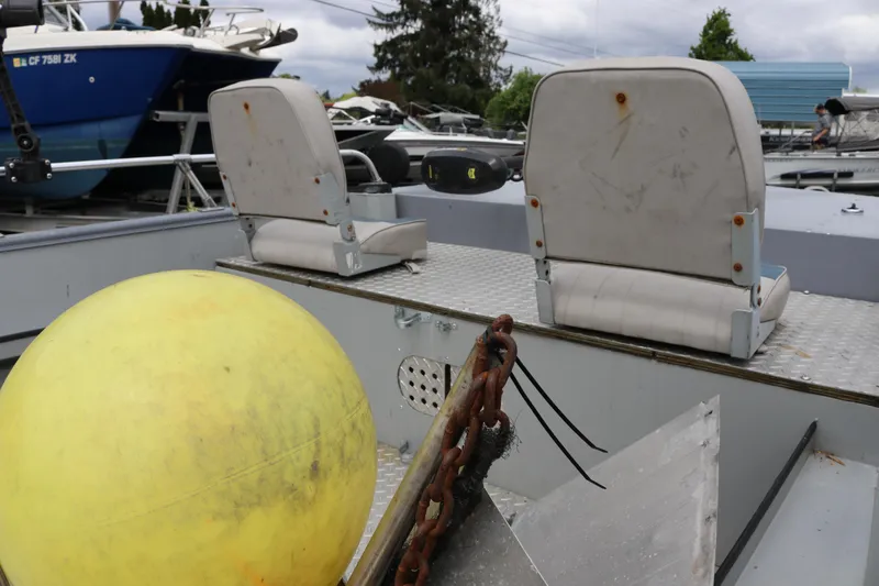 Slide: The Image of 2002 Smoker Craft Sportsman 1860 DLX boat interior with seats and yellow buoy. - 9