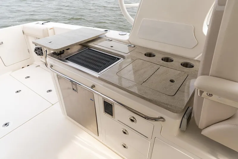 Slide: The Image of Manufacturer Provided Image: 2022 Boston Whaler 380 Realm boat galley with grill and storage compartments. - 10
