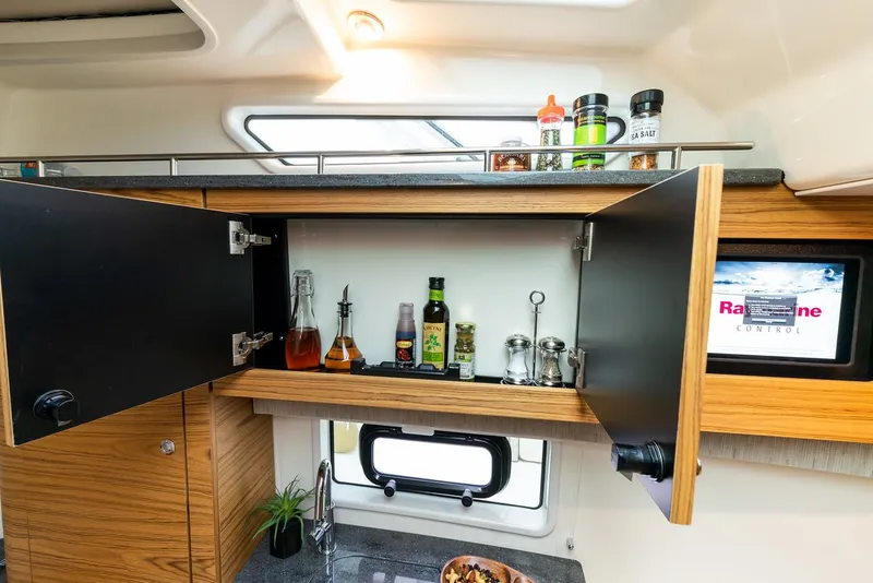 Slide: The Image of Manufacturer Provided Image: 2022 Boston Whaler 380 Realm kitchen cabinet with spices and condiments. - 15