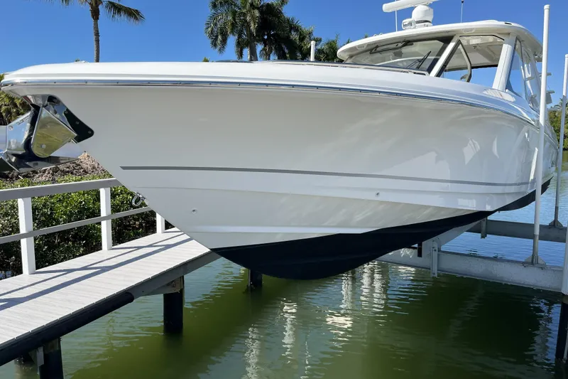 Slide: The Image of 2022 Boston Whaler 380 Realm boat docked on a sunny day. - 18
