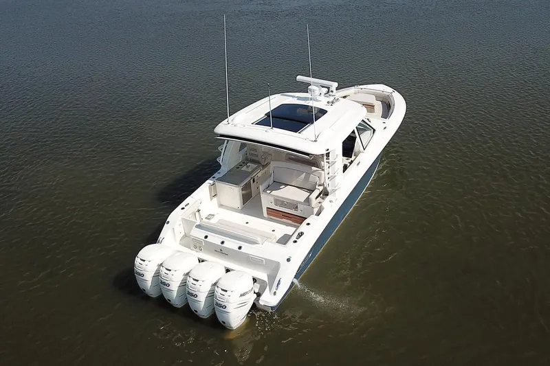 Slide: The Image of Manufacturer Provided Image: 2022 Boston Whaler 380 Realm boat with triple outboard engines on water. - 2