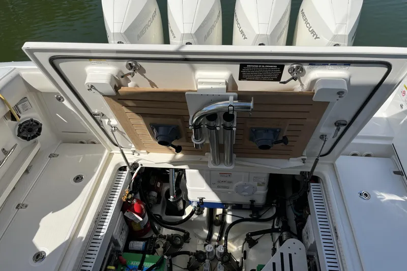 Slide: The Image of Boston Whaler 380 Realm 2022 engine compartment with Mercury outboards and equipment. - 20