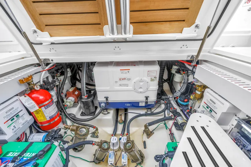 Slide: The Image of Engine compartment of a 2022 Boston Whaler 380 Realm, showcasing equipment and wiring. - 27