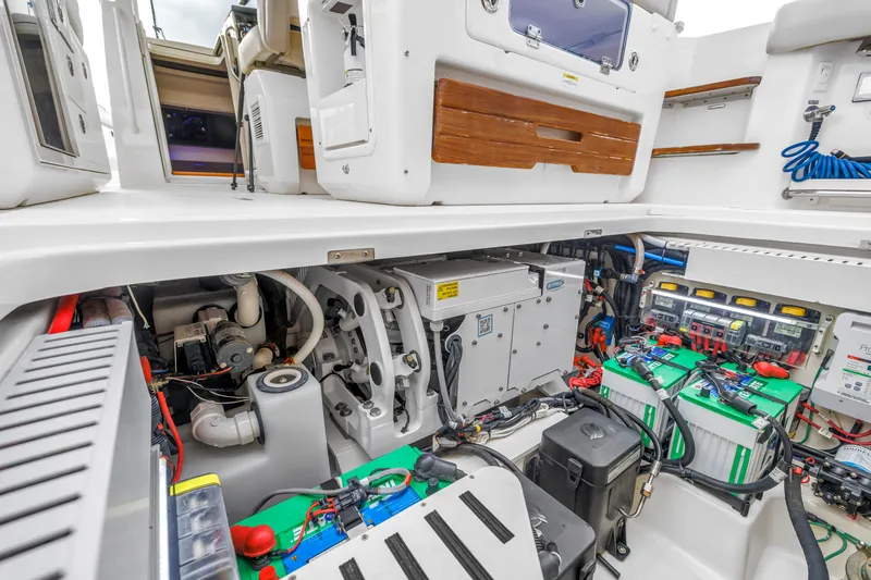 Slide: The Image of Engine compartment of 2022 Boston Whaler 380 Realm, showcasing batteries and mechanical systems. - 29