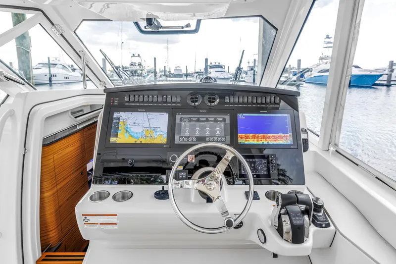 Slide: The Image of Cockpit of 2022 Boston Whaler 380 Realm with advanced navigation displays and controls. - 32